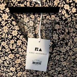 Blouse ploy-rayon silky feel size large button front. New with tags.